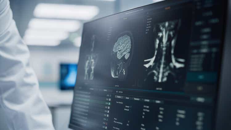 Medical Hospital: Neurologist and Neurosurgeon Talk, Use Computer, Analyse Patient MRI Scan, Diagnose Brain. Brain Surgery Health Clinic Lab: Two Professional Physicians Look at CT Scan. Close-up