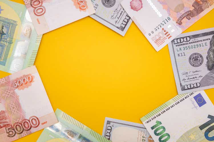 Currency dollar, euro, ruble on a yellow background. Copy space. Flat lay Stock