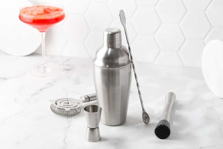 Cocktail equipment, barman, bartender tools set. Shaker, strainer on white background. Orange coctail.