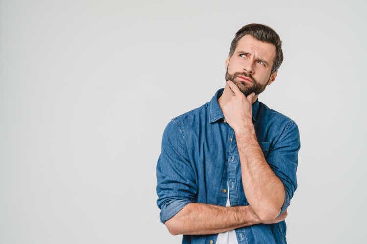 Pensive thoughtful contemplating caucasian young man thinking about future, planning new startup looking upwards isolated in white background