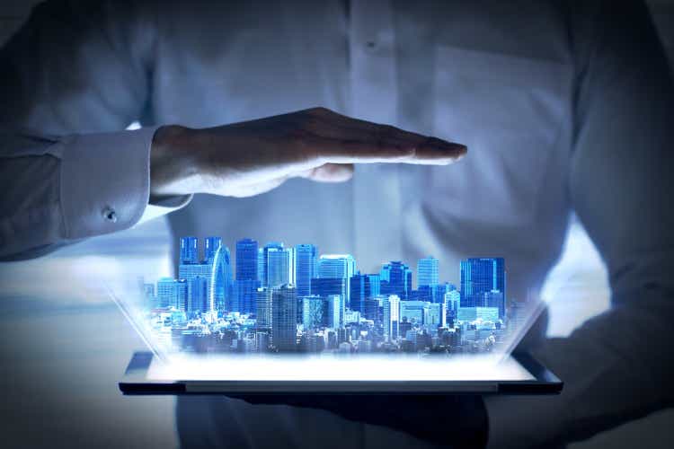 Holographic image of urban development that emerges from the tablet