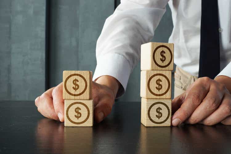 Portfolio diversification is shown on the photo using wooden cubes with signs of dollar