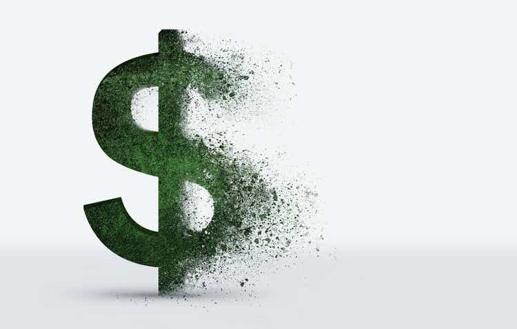 dollar sign crumbles into dust