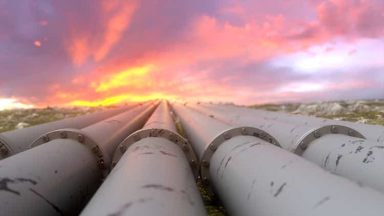 Industrial pipelines and valves on sunset sky background, banner.