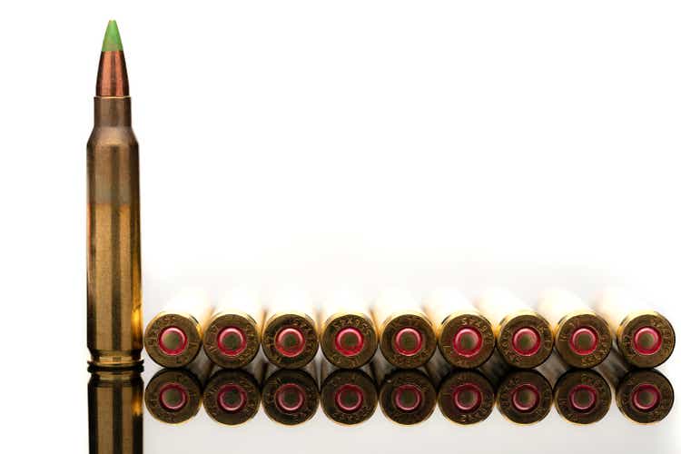 A group of 5.56 calibar, green tip bullets ordered into the line
