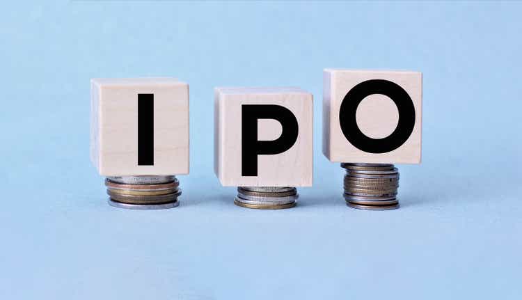 IPO letter blocks and stacked coins. IPO stands for Initial Public Offering.