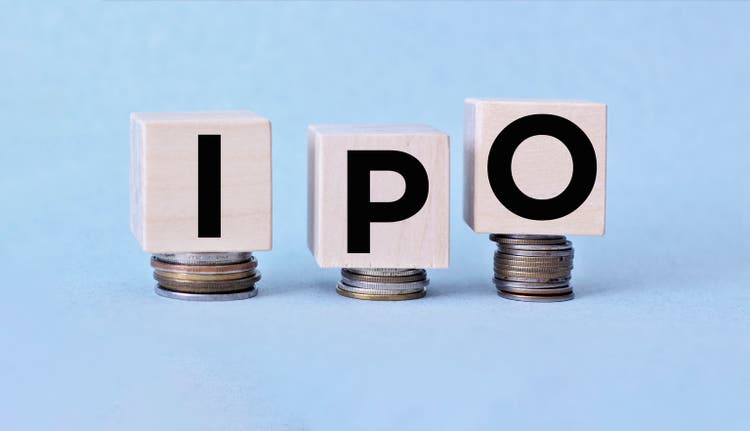 IPO letter blocks and stacked coins. IPO stands for Initial Public Offering.