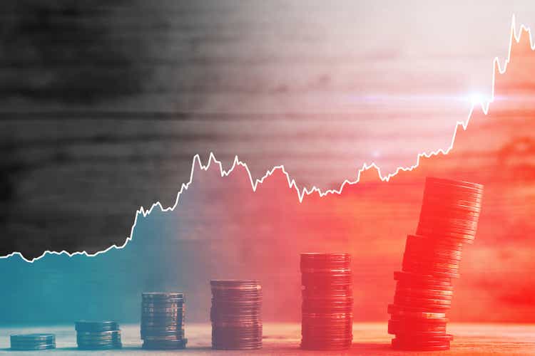 Unstable stacks of small value euro coins and rising sparkline chart