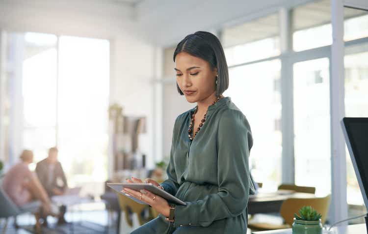 Shot of a young businesswoman using a digital tablet in a modern office