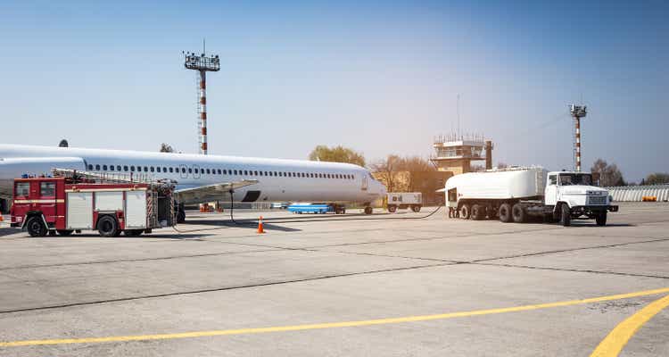 Aircraft refueling with a high pressure tanker. A passenger jet is being refueled from a supply truck. Airport Service