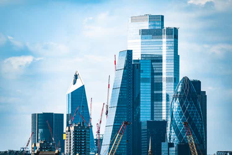 London City skyscrapers overlooking homes along River Thames