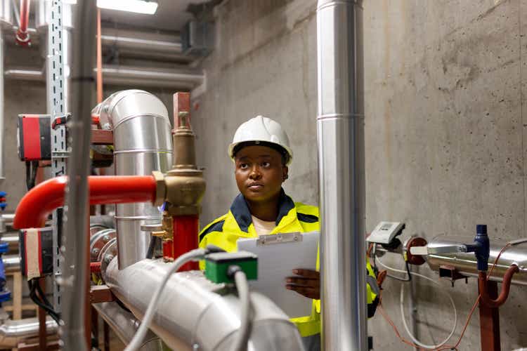 Female Heating Engineer In Boiler Room