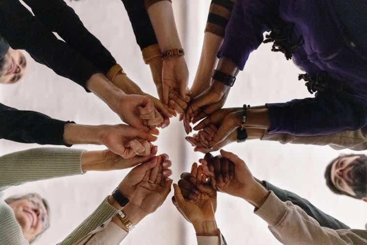 People with fist put together during support group session