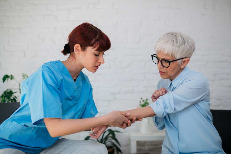 Female medical professional examining a senior patient