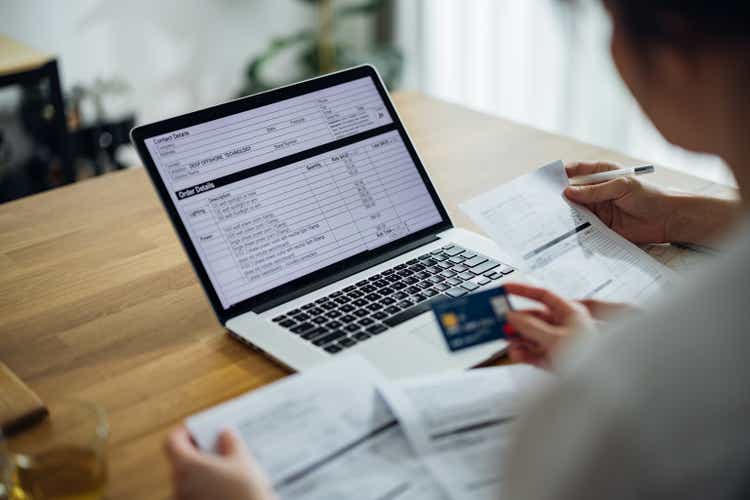 Unrecognizable Couple Paying Bills at Home