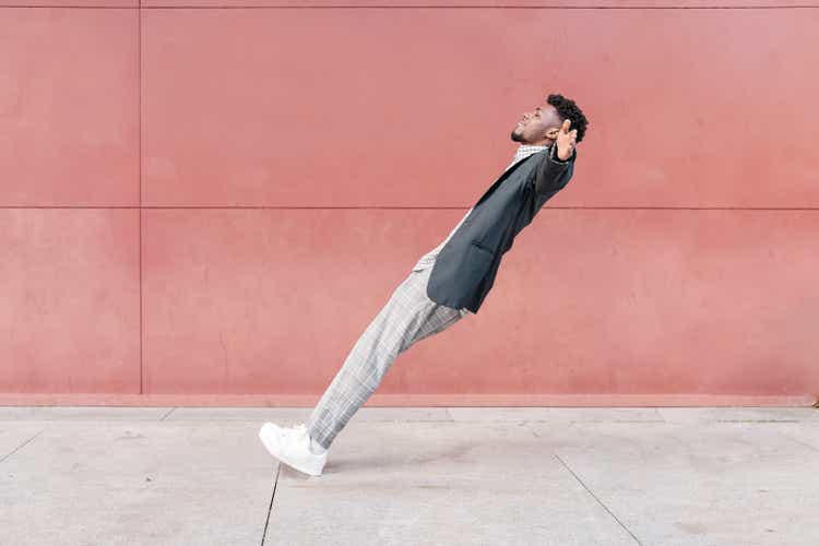 african-american man falling backwards onto concrete floor