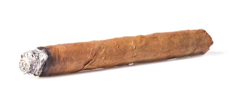 Burning brown cuban cigar isolated on white background
