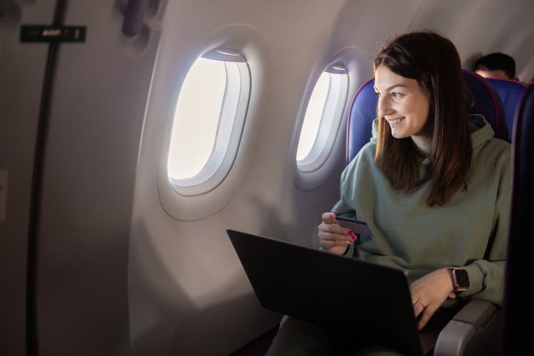 Girl traveling by a plane and shopping online
