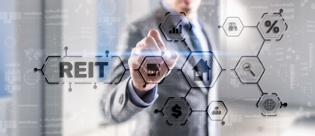 REIT. Real estate investment trust. Financial Market. Hand pressing button on screen