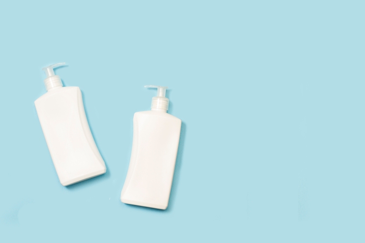Soap gel bottles on a light blue background