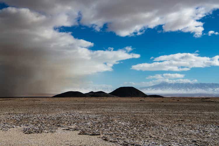 Dust storm in desolate, barren desert landscape showing the environmental damage from lithium mine operations at Silver Peak Albemarle Mine in Nevada, USA