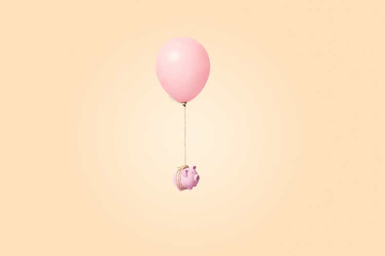 pink piggy bank tied to a balloon