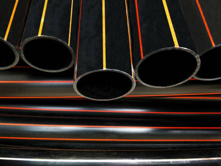 Pile of HDPE pipes conduit for underground electrical wiring installation