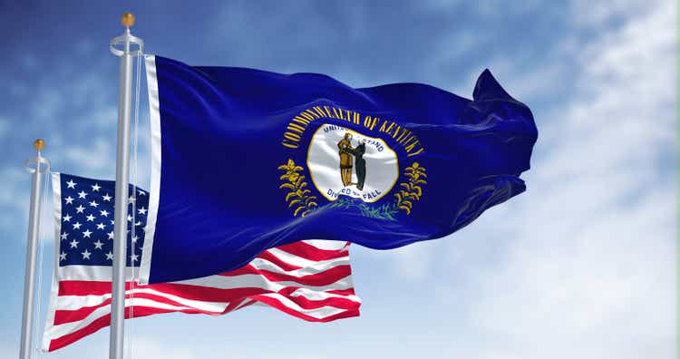 The Kentucky state flag waving along with the national flag of the United States of America