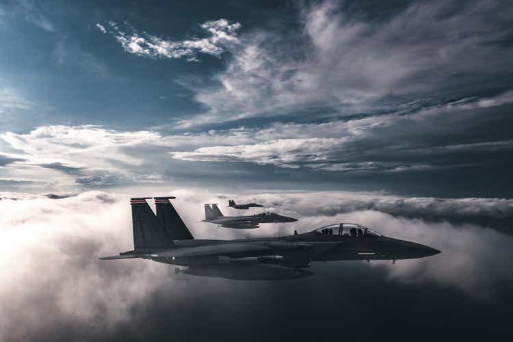 Jet fighters flying over the clouds.