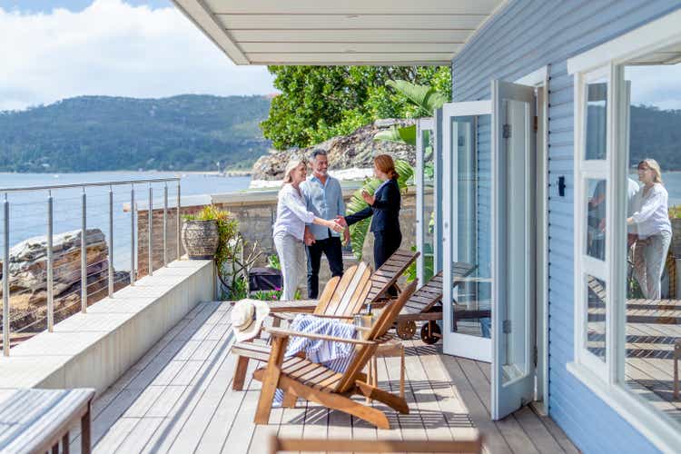 Real estate agent showing a mature couple a new house.