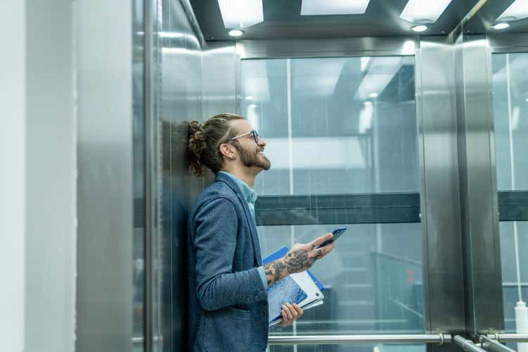 Businessman in elevator.