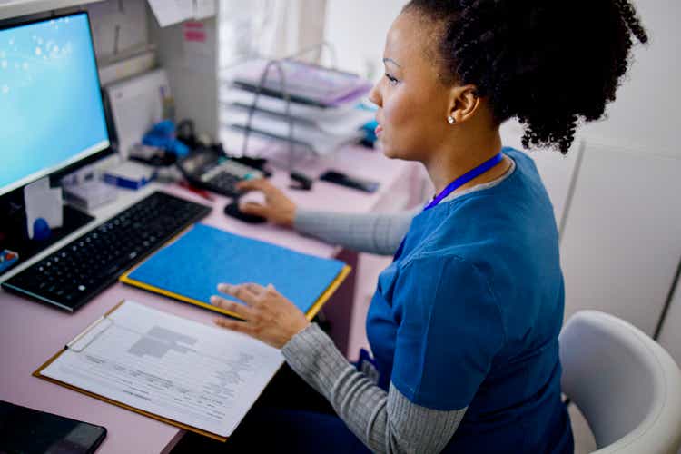 Nurse working at the reception desk in the private clinic