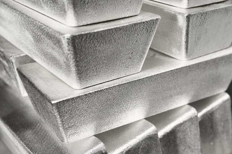 Stack of industrial silver ingots at bright light in storage