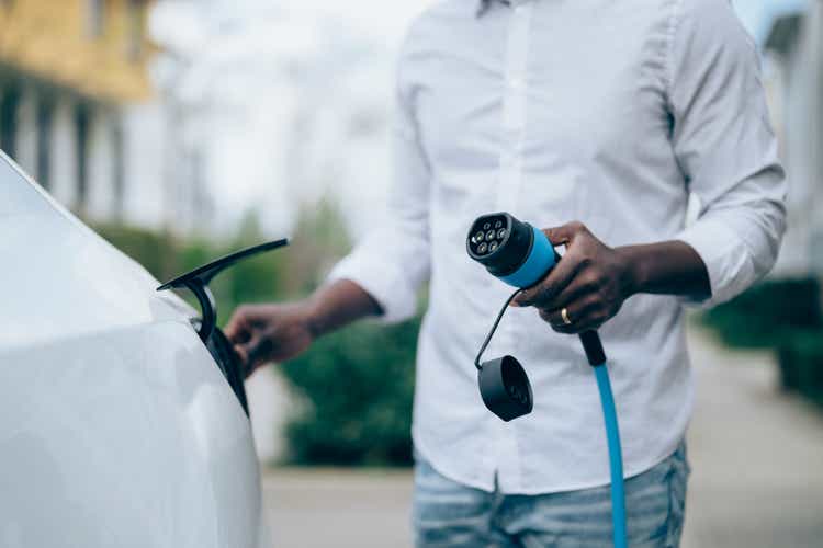 Man charging electric car