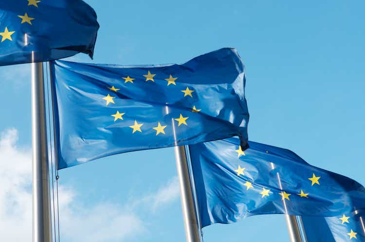 Four European Union flags waving in the wind