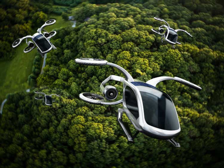 Conceptual eVTOL (electric vertical take-off and landing) aircrafts flying against a dense forest background