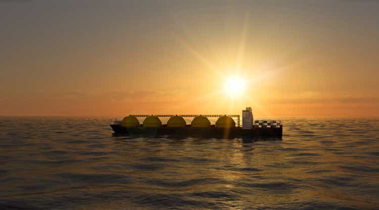 Floating regasification facility, regasification facility stationary in the sea. Sunset.