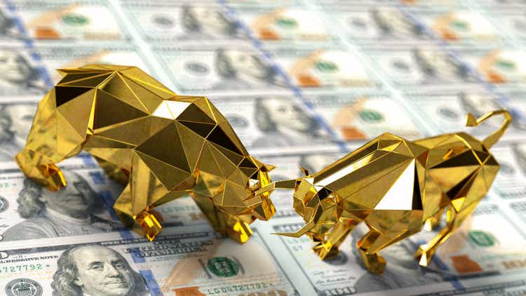 Golden Bull Market and Bear Market Sign Battle on US Dollar Banknotes