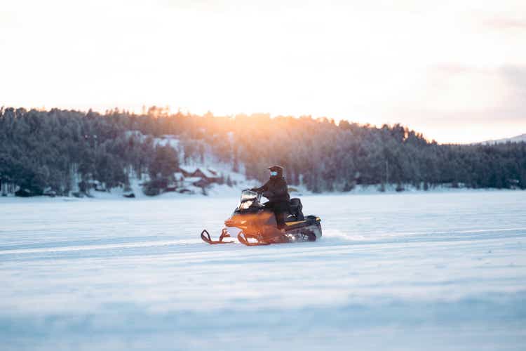 snowmobile on frozen lake .