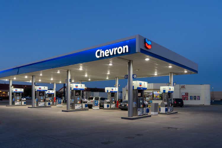 A Chevron gas station at night is shown in Dallas, Texas, USA.