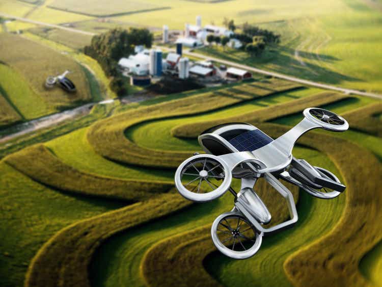 Conceptual eVTOL (electric vertical take-off and landing) aircraft flying over rural areas
