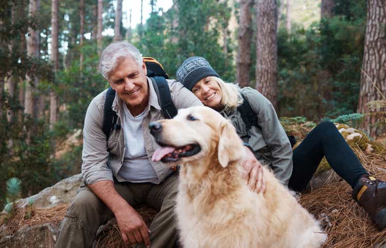 Shot of a senior couple out hiking with their dog