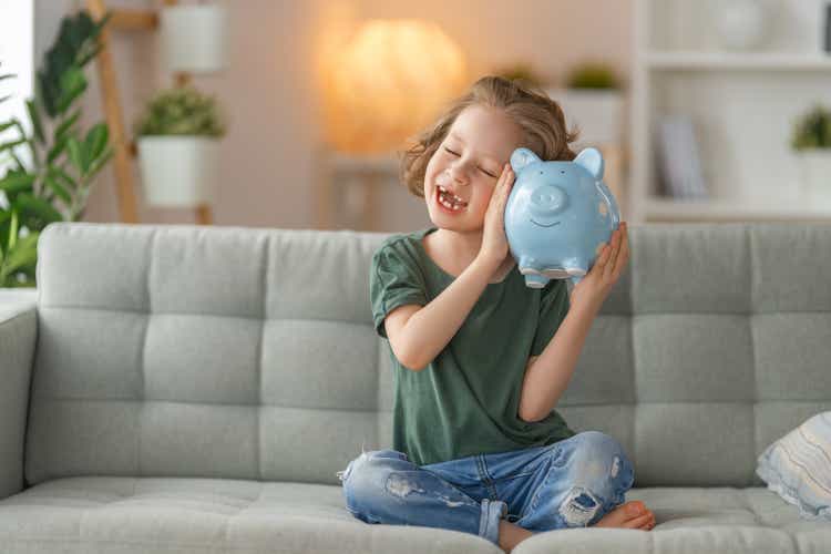 Happy girl with piggy bank