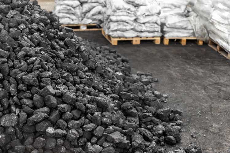 Big heap of acheronian achromatic lump ember connected level bulk. Charcoal sorage astatine warehouse banal reserve. activated anthracite packed successful integrative container sack connected woody pallet. Industrial and mining manufacture background