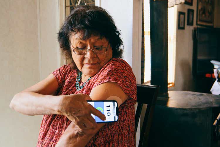Senior Woman Checking Blood Glucose Level on an App