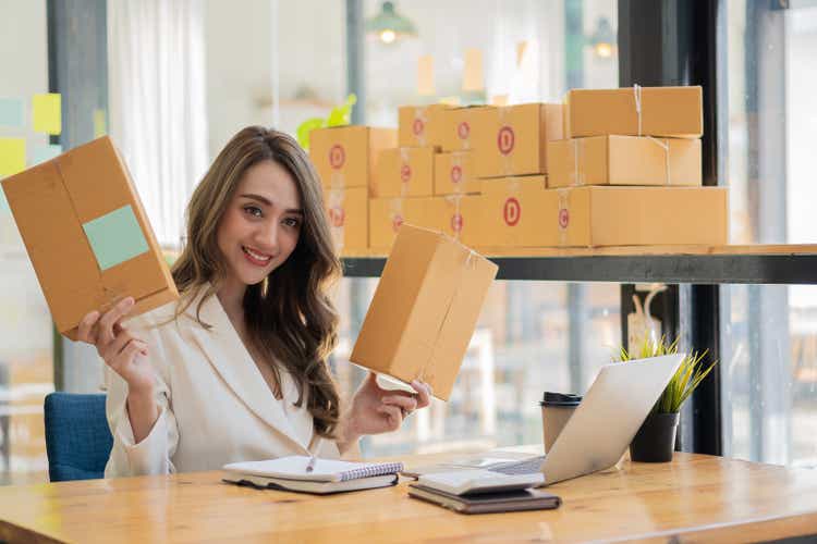 Starting a Small Business, SME Entrepreneur or Freelance Asian Woman Using Laptop for Work, Successful Asian Woman with Box Delivery Business, Online Marketing and Delivering, SME Concepts.