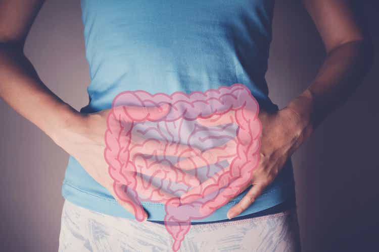 woman hands on her stomach with intesline, probiotics food for gut health, colon cancer, bowel inflammatory concept