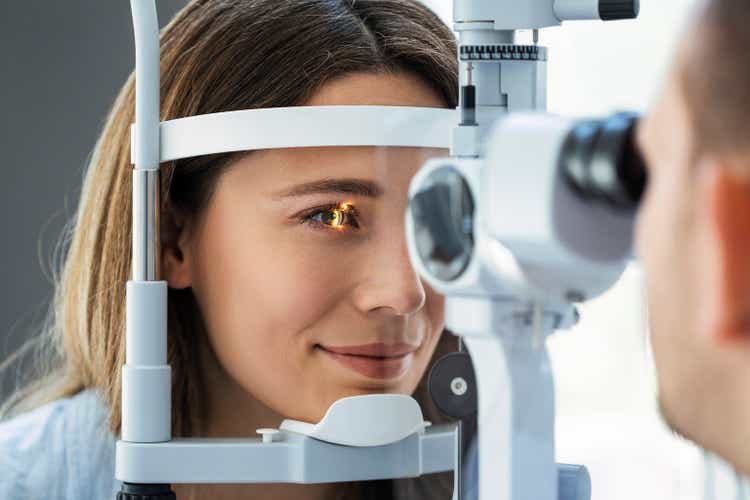 Beautiful young girl checking the eye vision in ophthalmology clinic