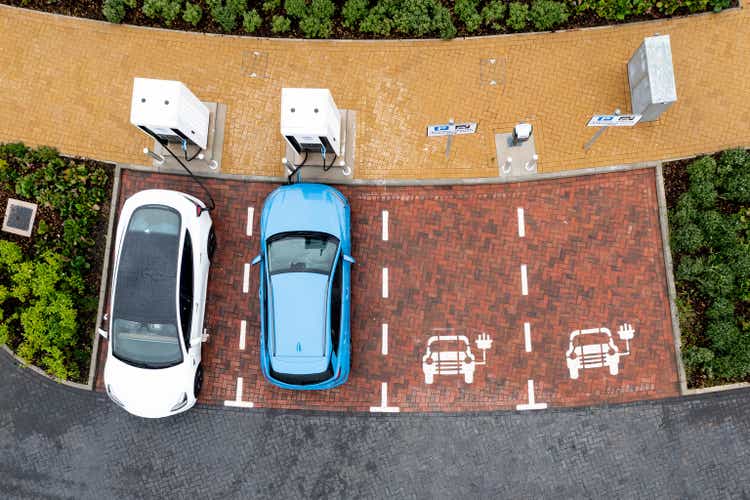 Aerial view over a charged electric car live