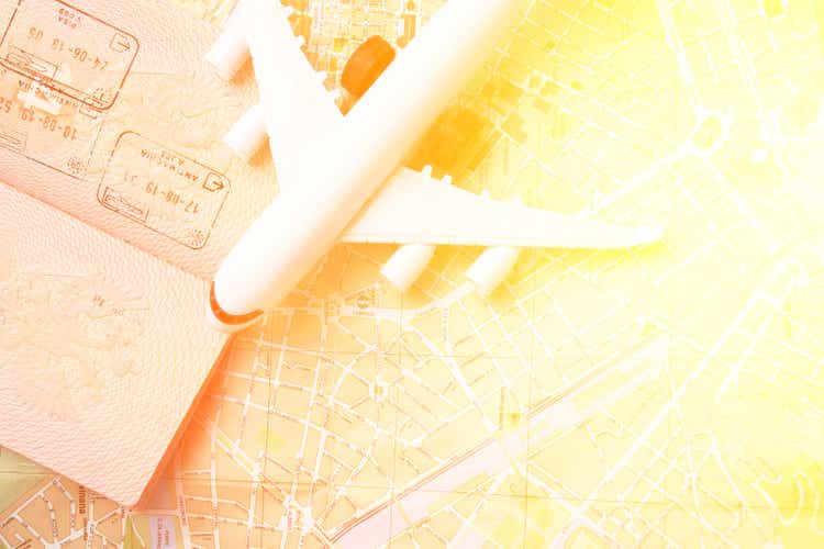 summer travel, travel agencies, online air tickets, hotel booking, airplane with a passport and a map with copy space